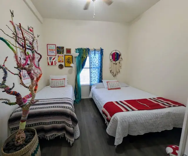 Bedroom with a twin bed and a queen-size futon side by side